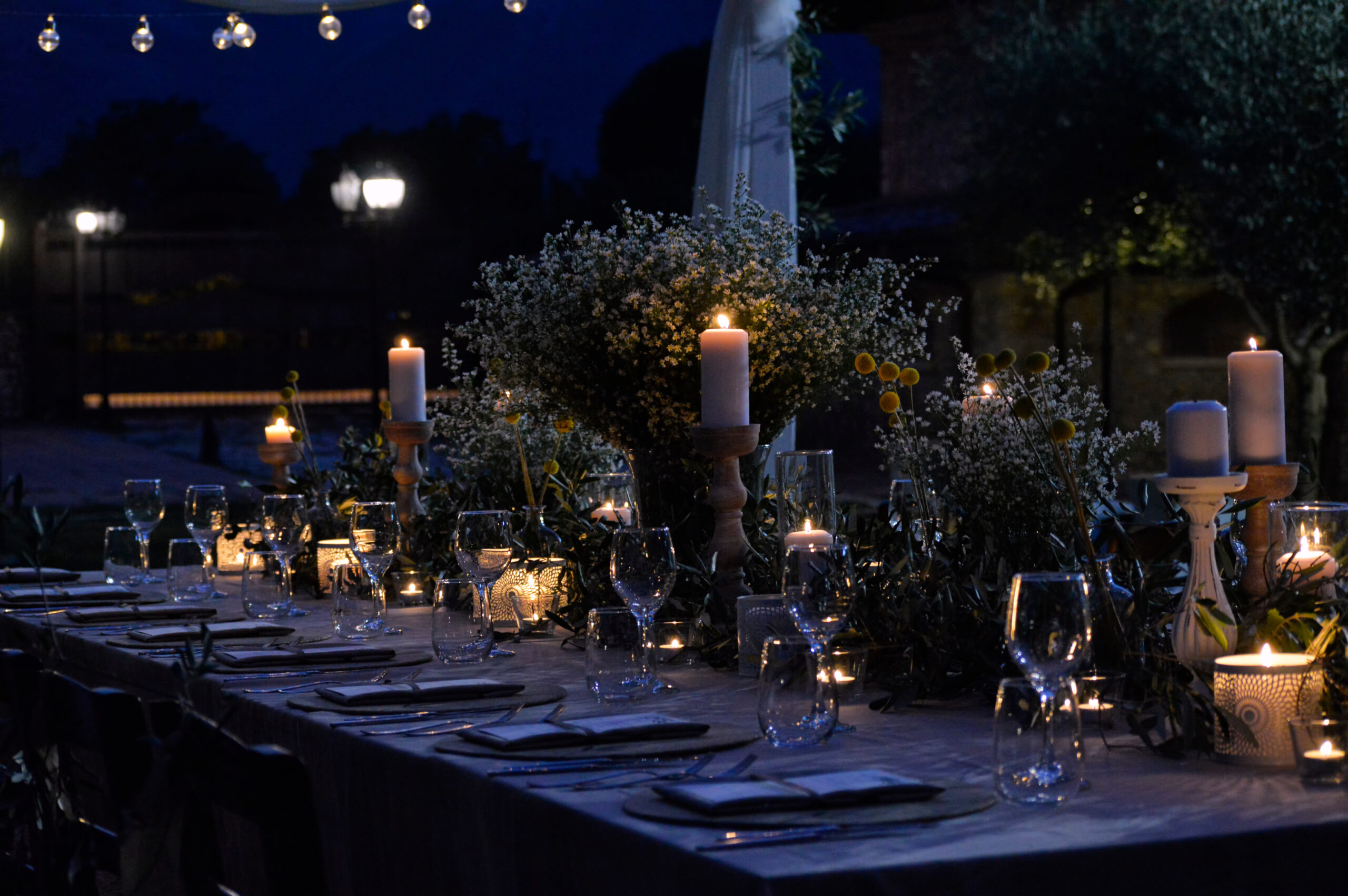 Candlelit outdoor fundraiser gala dinner table setting at night — full-service catering in the Bay Area