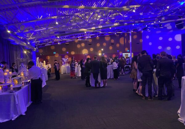 Guests mingling at an evening corporate holiday party in the Bay Area
