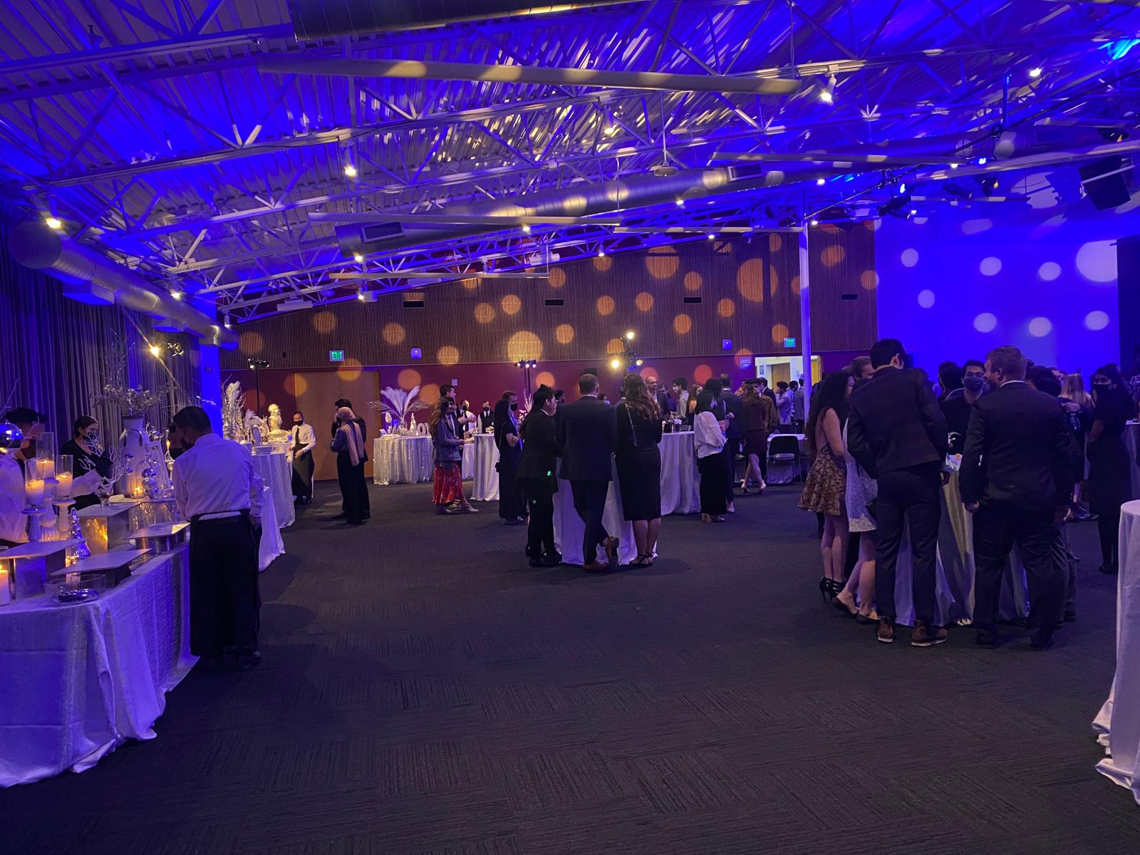Guests mingling at an evening corporate holiday party in the Bay Area