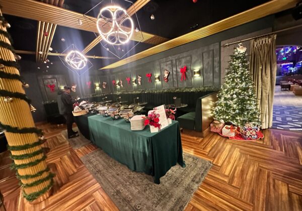 Lounge decorated with a Christmas tree, set for a corporate holiday party